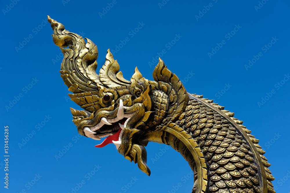 Fototapeta premium Naga statue head with blue sky background.