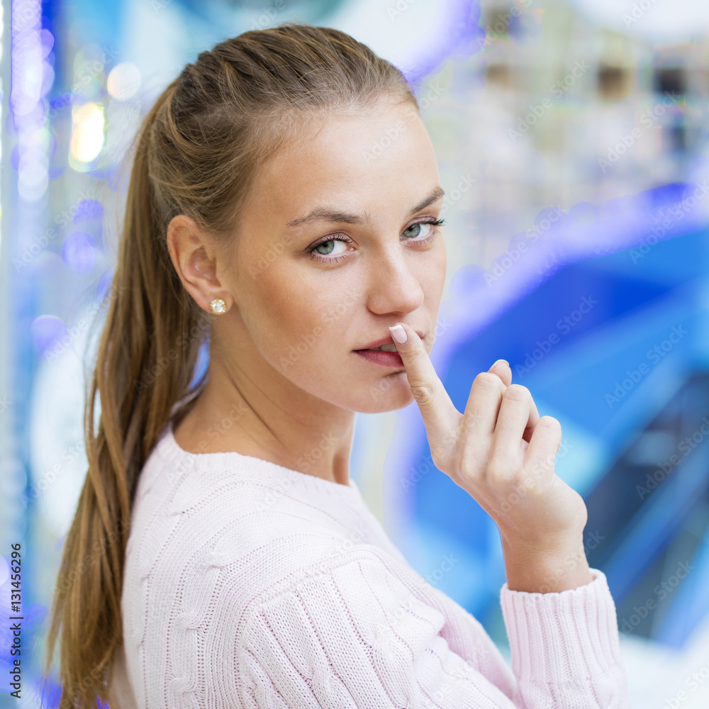 Young beautiful blonde woman has put forefinger to lips as sign Young beautiful blonde woman has put forefinger to lips as sign
