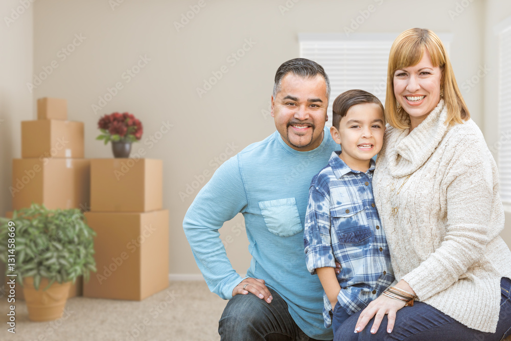 Happy Mixed Race Family with Son in Room with Packed Moving Boxes. Happy Mixed Race Family with Son in Room with Packed Moving Boxes.