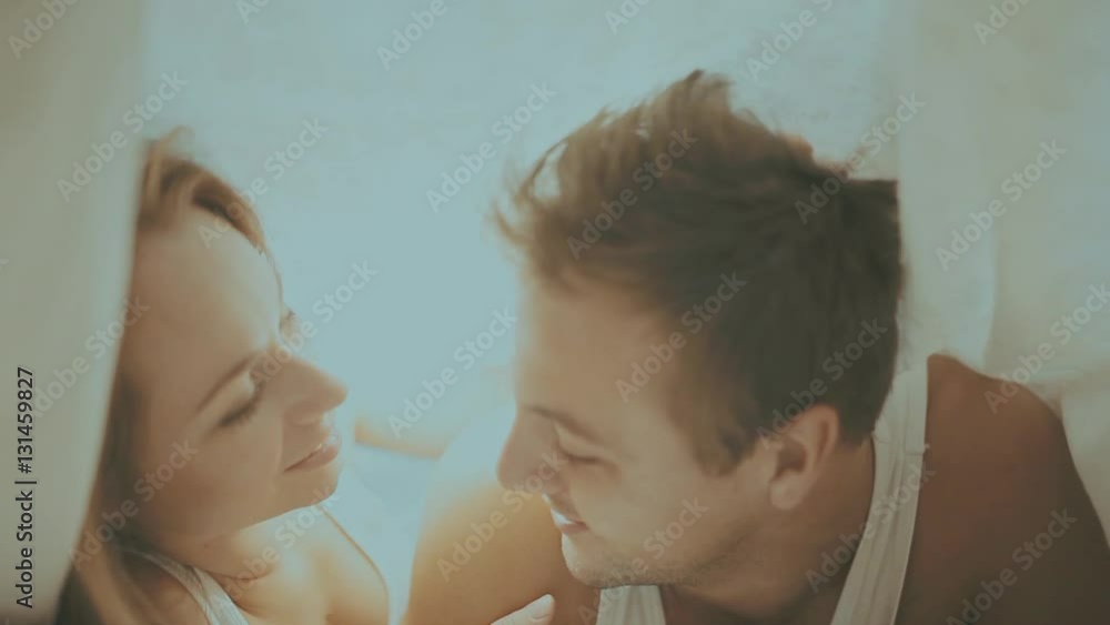 Close up portrait of romantic young man and woman in bed at home. Relationships, love, closeness. Close up portrait of romantic young man and woman in bed at home. Relationships, love, closeness.