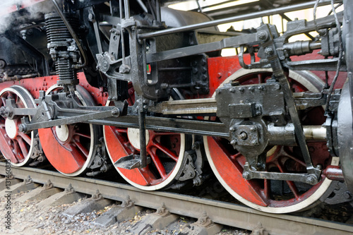 Wheels of black steam locomotive Er-794-12 on railway