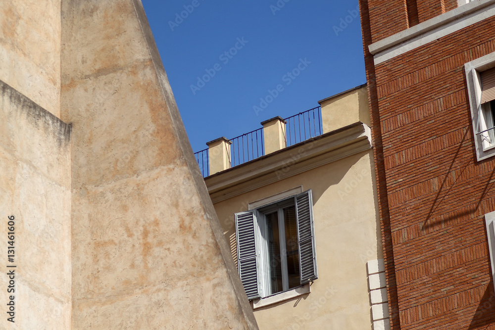 Building facade with windows, on blue sky, Rome, Italy Building facade with windows, on blue sky, Rome, Italy
