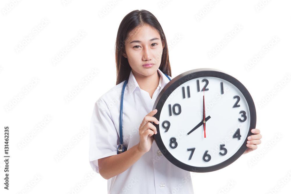 Frustrated Young Asian female doctor with a clock. Frustrated Young Asian female doctor with a clock.