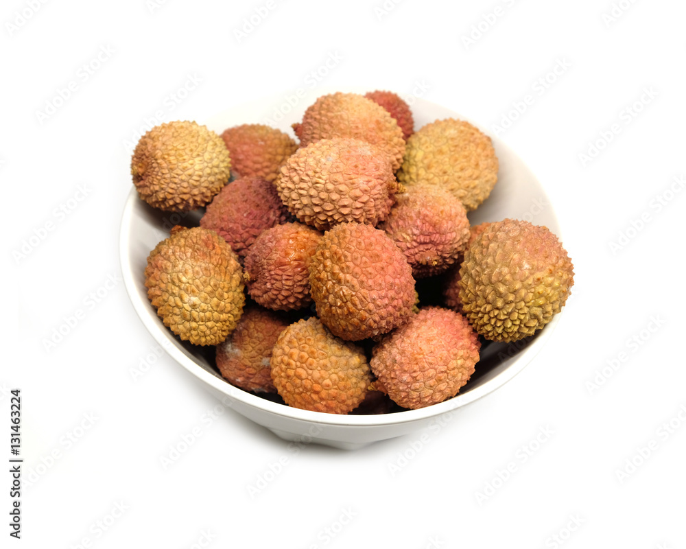 Many ripe litchi fruits isolated in white bowl top view closeup Many ripe litchi fruits isolated in white bowl top view closeup