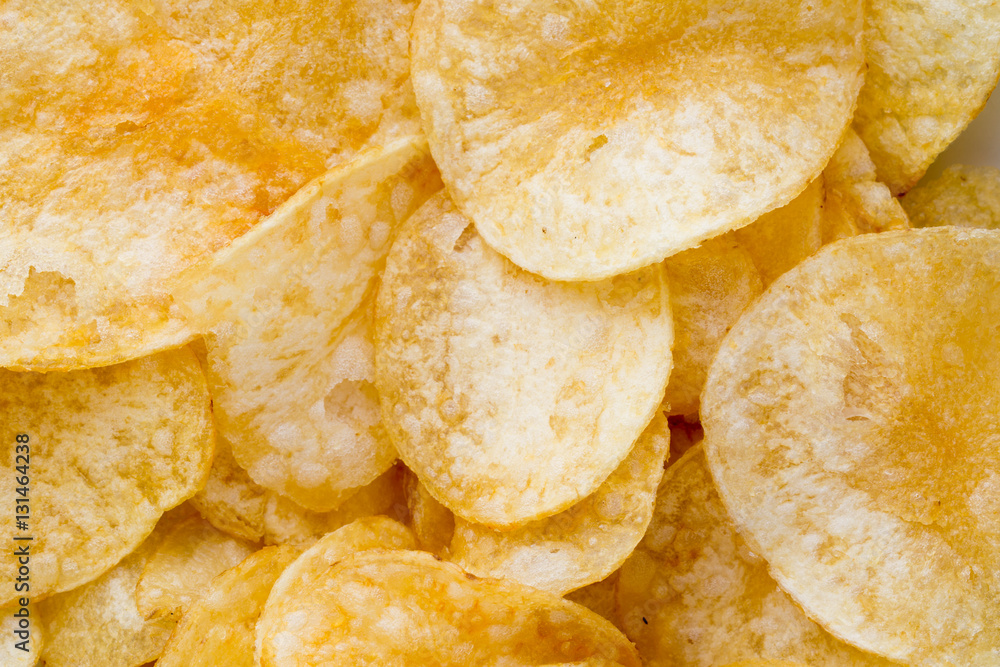 Close up potato chips on wood top view background. Close up potato chips on wood top view background.