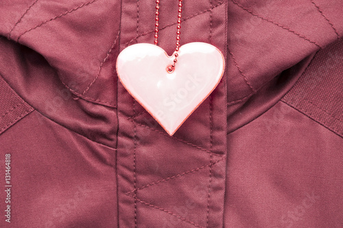 Bild auf Leinwand Cute rose safety reflector in the form of heart on the winter jacket