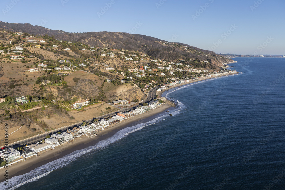 Aerial of Pacific coast homes and mountains in Malibu California.