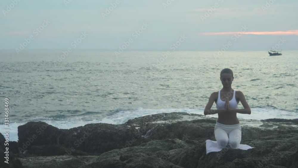 Girl Doing Yoga Exercises On The Sea Coast Girl Doing Yoga Exercises On The Sea Coast