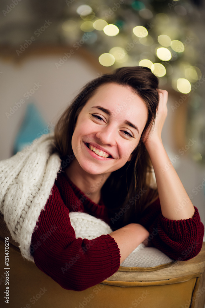 Portrait of pretty young woman in evening dress smiles in Christmas Portrait of pretty young woman in evening dress smiles in Christmas