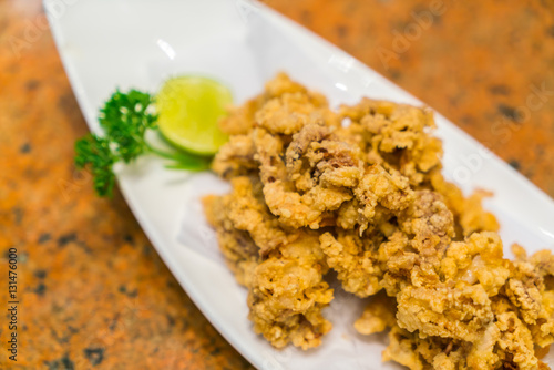 Fried squid on white plate .