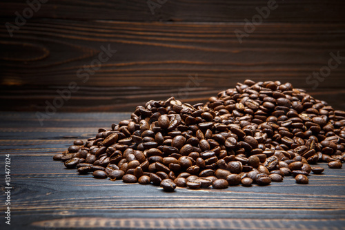 roasted coffee beans on wooden background © Anatoly Repin