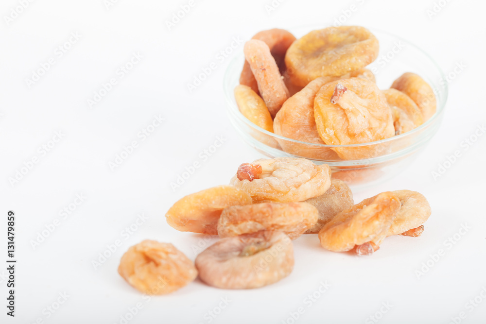 Dried figs in glass bowl on white background