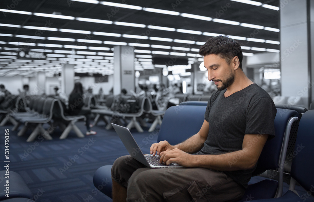 Man use notebook or laptop computer in the airport Man use notebook or laptop computer in the airport