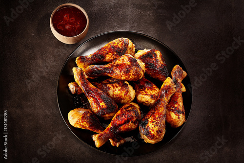 Plate of grilled spicy chicken with chili sauce