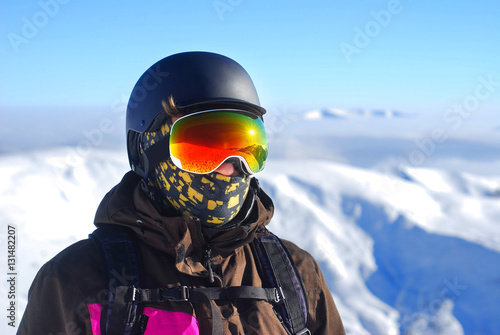 Portrait of a boy in a protective helmet and snowboard mask agai © Krafla