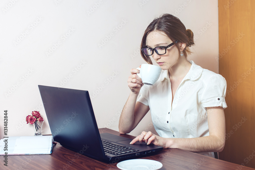 attractive girl with the glasses typing on a laptop attractive girl with the glasses typing on a laptop