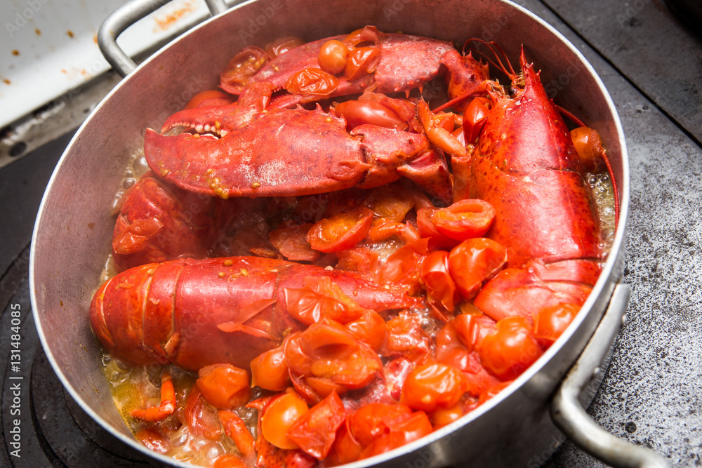 Astici cucinati rossi in pentola con pomodori Astici cucinati rossi in pentola con pomodori