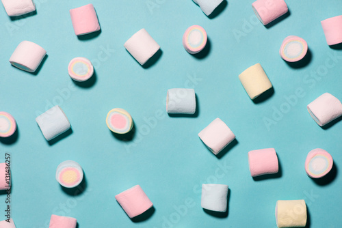 Top view of pastel colored marshmallow on a blue background. Min photo