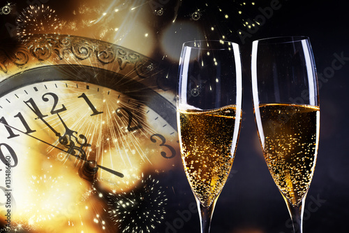 Photography toasting with champagne glasses against holiday lights