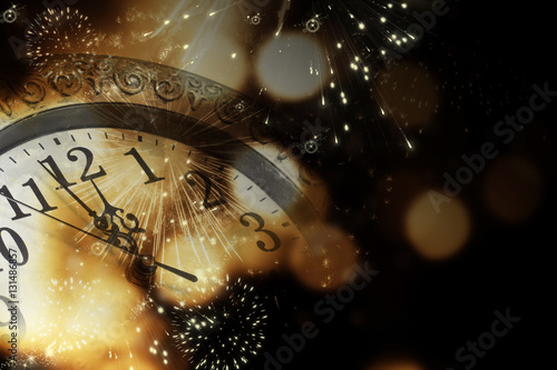 old clock with fireworks and holiday lights