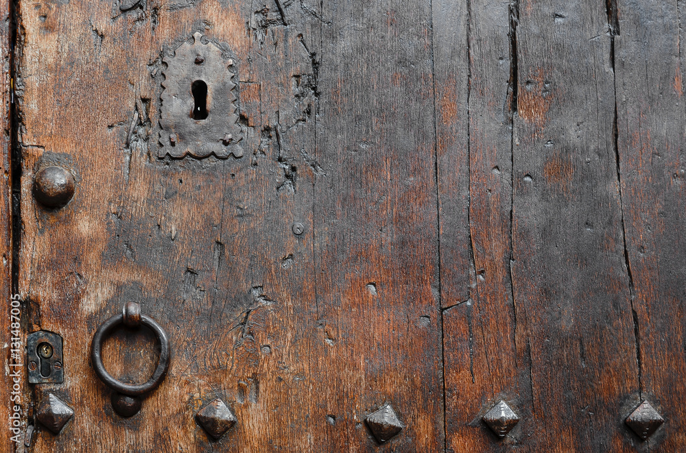 Antique wooden door close-up and rusty iron knocker. Antique wooden door close-up and rusty iron knocker.