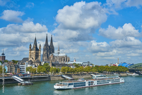 panorama of the city Cologne with Cathedral, boats, river Rhine and bridge in a sunny day, Germany