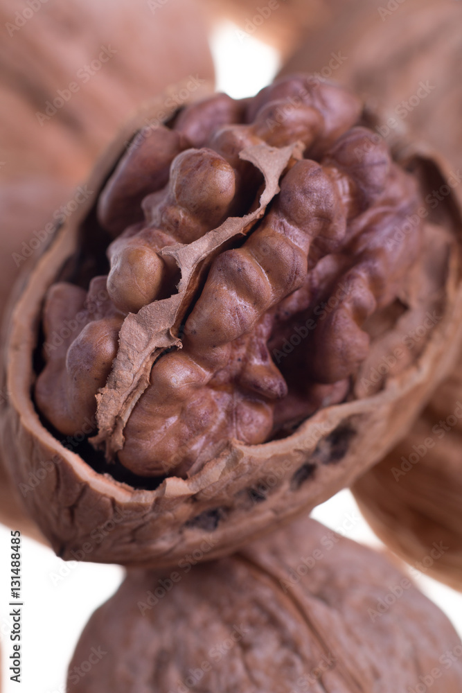 Shelled walnuts on a white background. Isolated. Dried nuts. Close up. Shelled walnuts on a white background. Isolated. Dried nuts. Close up.