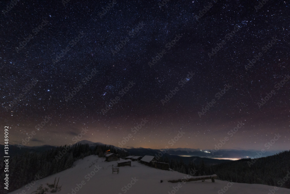 Naklejka premium The Milky Way over the winter mountains landscape