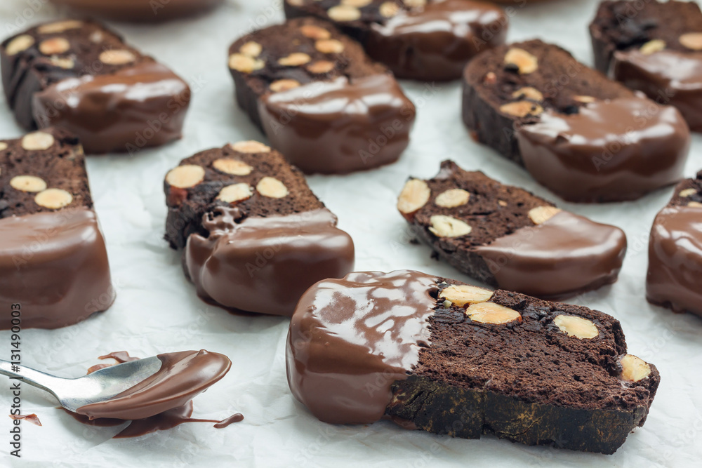 Homemade dark chocolate biscotti cookies with almonds, covered with melted chocolate, horizontal Homemade dark chocolate biscotti cookies with almonds, covered with melted chocolate, horizontal