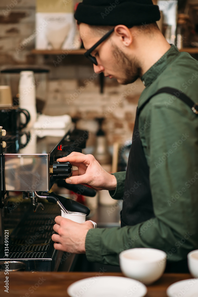 Man hands pours drink from a coffee machine. Man hands pours drink from a coffee machine.