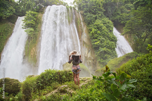 Young woman enjoying nature at Cikaso Waterfall photo