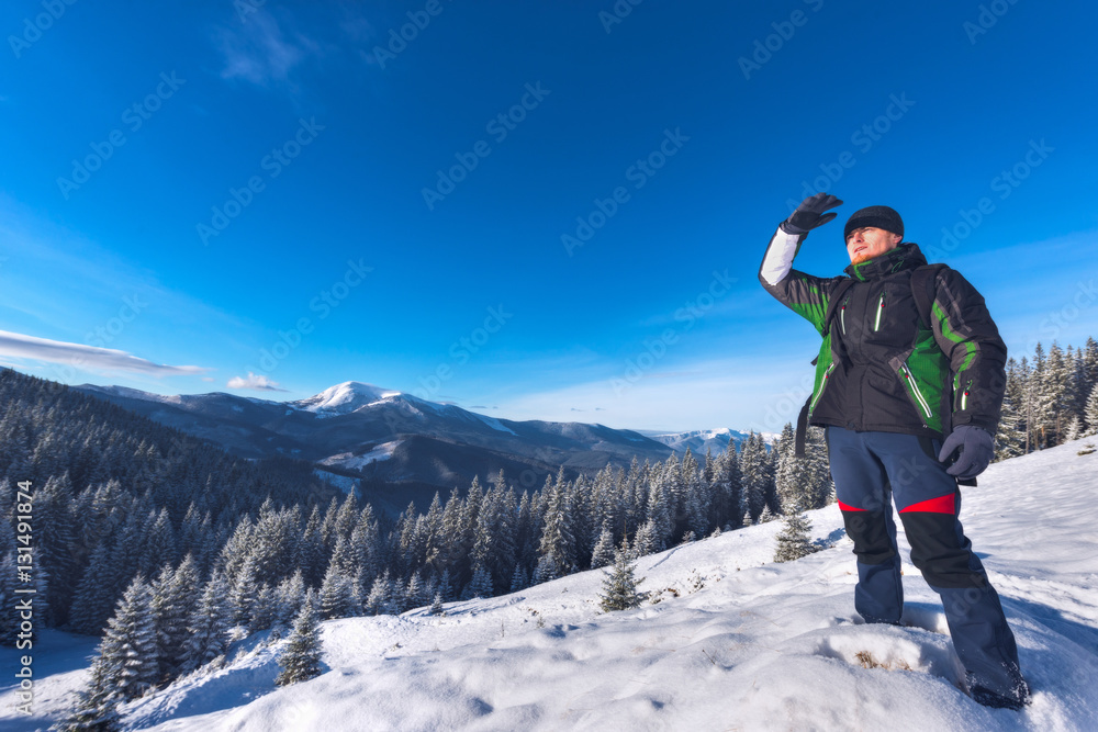 The traveler is looking for a way in the mountains in winter