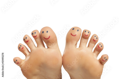 female foot and smiles drawn on the toes photo