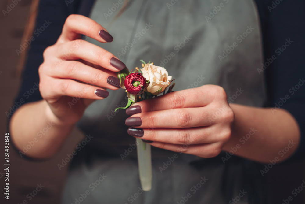 Florist hands creating flower decoration closeup. Florist hands creating flower decoration closeup.