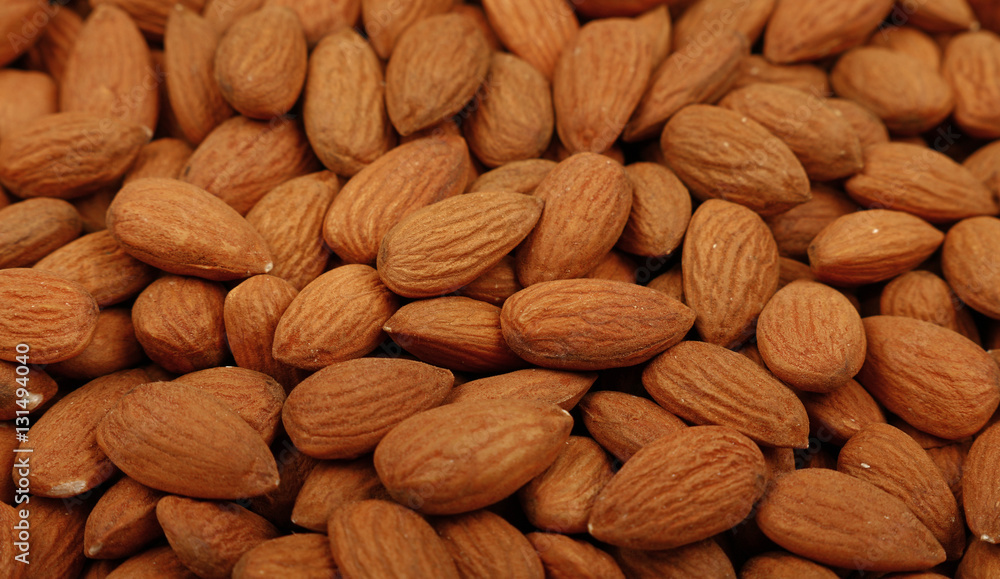 Raw whole almond nuts close up Raw whole almond nuts close up