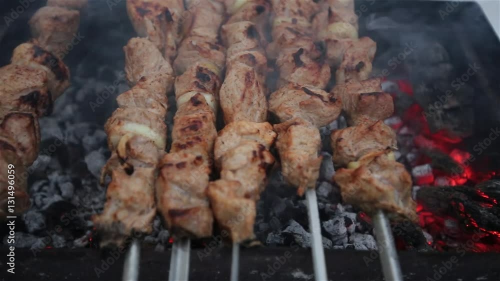 Pork shashlik fried on a skewer on the grill in the backyard in the winter. Pork shashlik fried on a skewer on the grill in the backyard in the winter.
