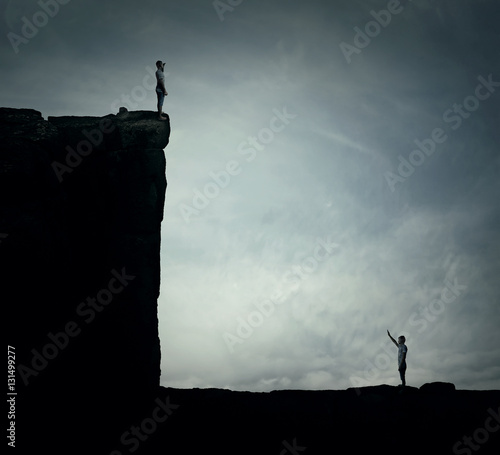 Conceptual image with two lost persons standing on a cliff at different hights, trying to find each other. Parallel world, alternate reality, multiverse fiction theory and relativity. Life cycle,