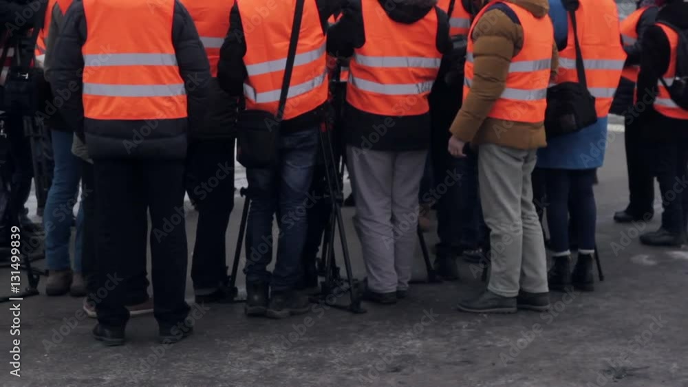 Media in work helmet and reflective vest at plant Media in work helmet and reflective vest at plant
