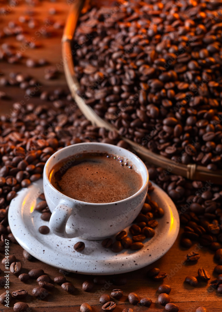 Cup of black coffee and roasted beans Cup of black coffee and roasted beans