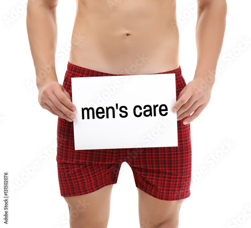 Man holding paper with text MEN'S CARE, closeup. Health care concept.