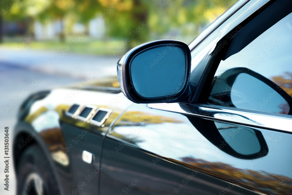 Mirror of luxury black car, closeup