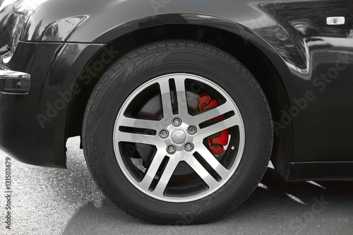 Wheel of luxury black car, closeup © Africa Studio