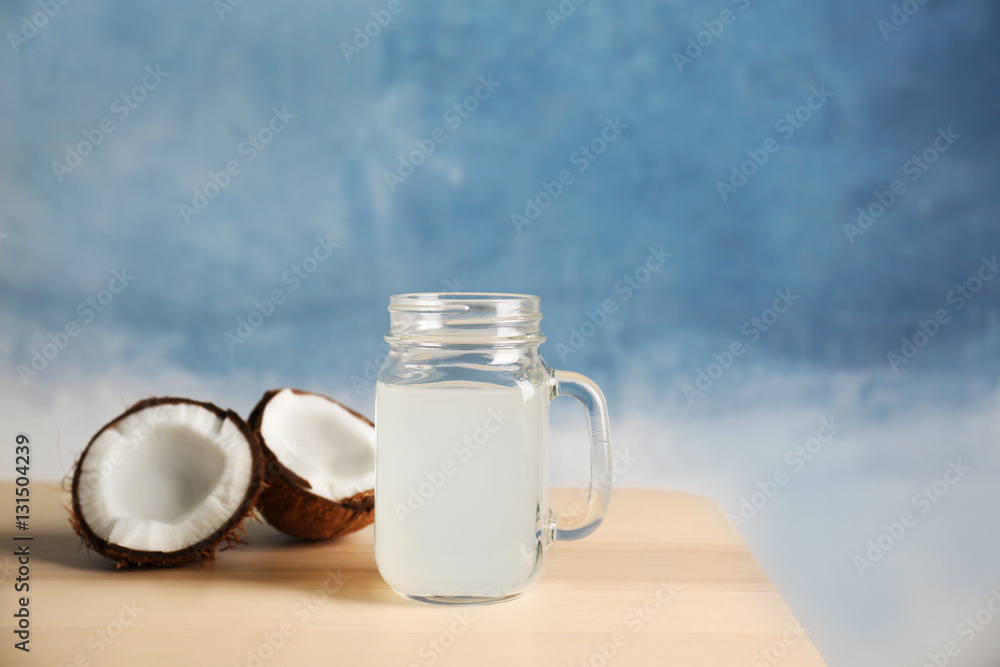 Glass of coconut milk and nuts on wooden table Glass of coconut milk and nuts on wooden table