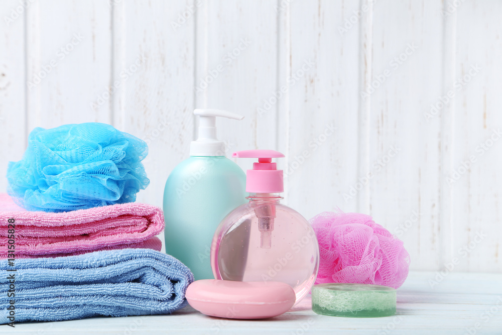Towels with soap and wisp on white wooden table Towels with soap and wisp on white wooden table