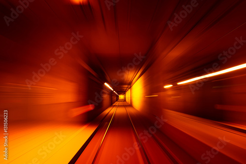 Speed motion blurred underground subway tunnel yellow color toned