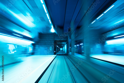 Underground subway tunnel blurred in speed motion and blue toned