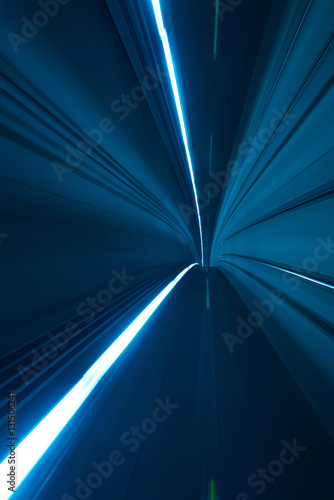 Speed motion blurred underground subway tunnel blue toned