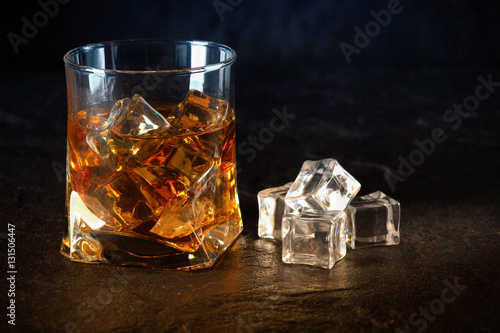 glass of whiskey with ice cubes