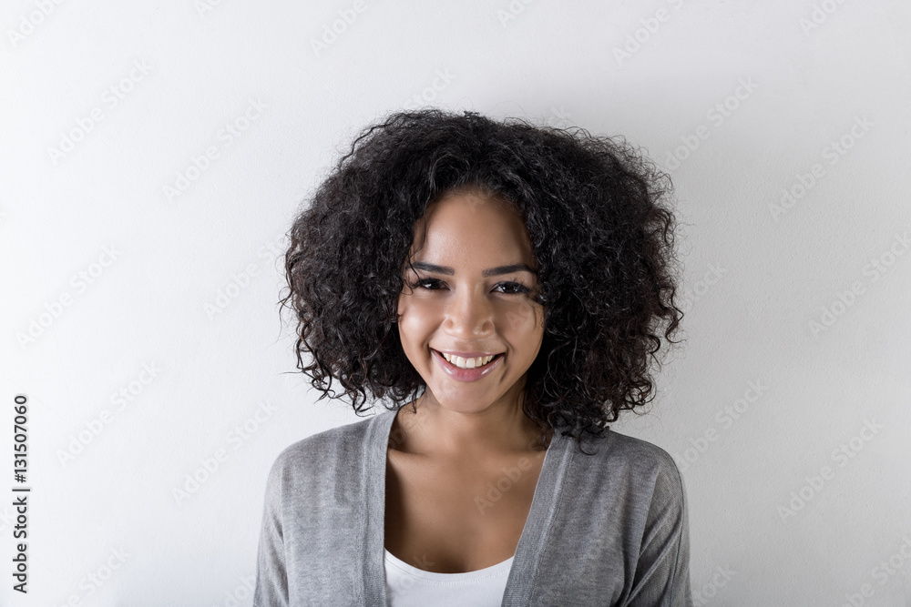 Portrait of an attractive woman smiling against white background Portrait of an attractive woman smiling against white background
