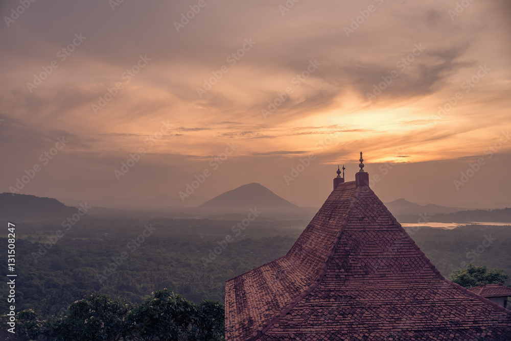 Naklejka premium Sri Lanka: Danbulla cave temple and national park at the sunset 